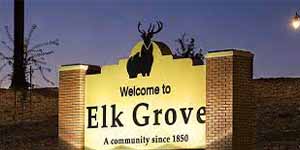 Welcome to Elk Grove sign illuminated at dusk, marking the entrance to the historic community established in 1850