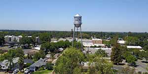 Aerial view of Galt water tower surrounded by residential neighborhoods and green trees on a sunny day