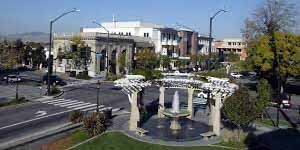 Downtown Livermore, CA plaza with a central water fountain and surrounding shops, representing the city’s lively community area