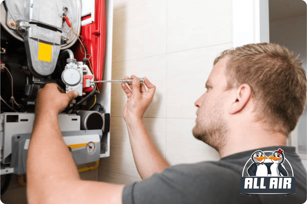 Friendly All Air HVAC technicians working together on rooftop air conditioning repair, providing expert service for reliable heating and cooling solutions