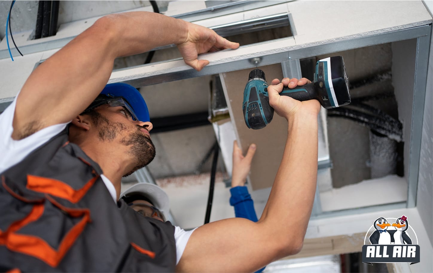 HVAC technician installing ceiling unit to improve indoor air quality